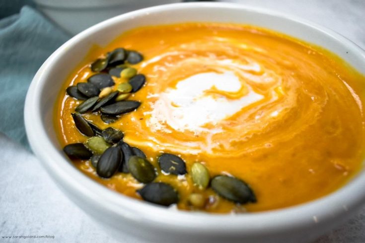 bowl of soup with pumpkin seeds on op